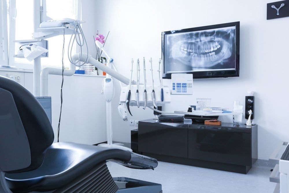 Modern Dental treatment room showing digital dental x-rays, and equipment